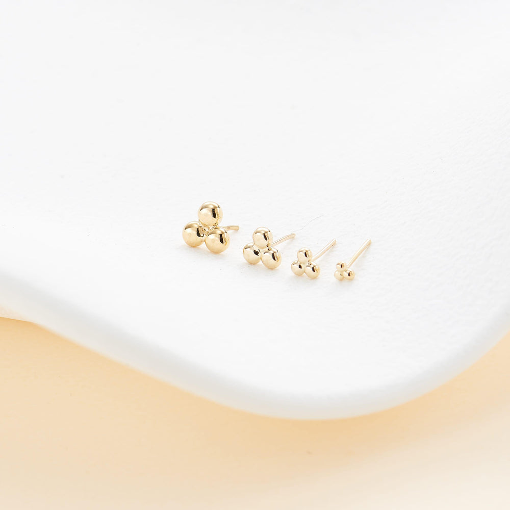 detail close-up of 14K solid gold trinity knot labret stud threadless design nickel-free