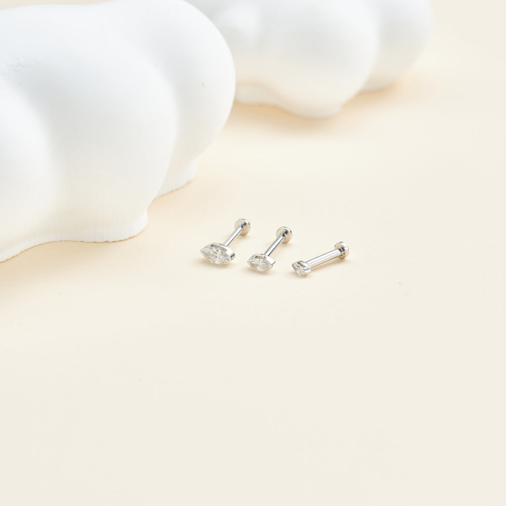 detail close-up of 14K solid gold marquise-cut lab diamond invisible setting flat back stud earring screw back design nick...