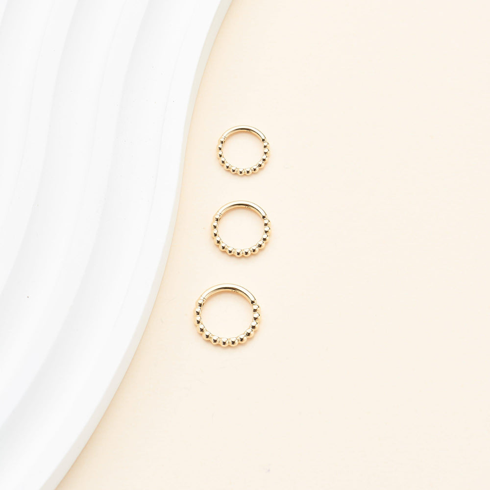side angle of 14K solid gold bubble-textured for conch daith septum cartilage piercing clicker hoop earring nickel-free