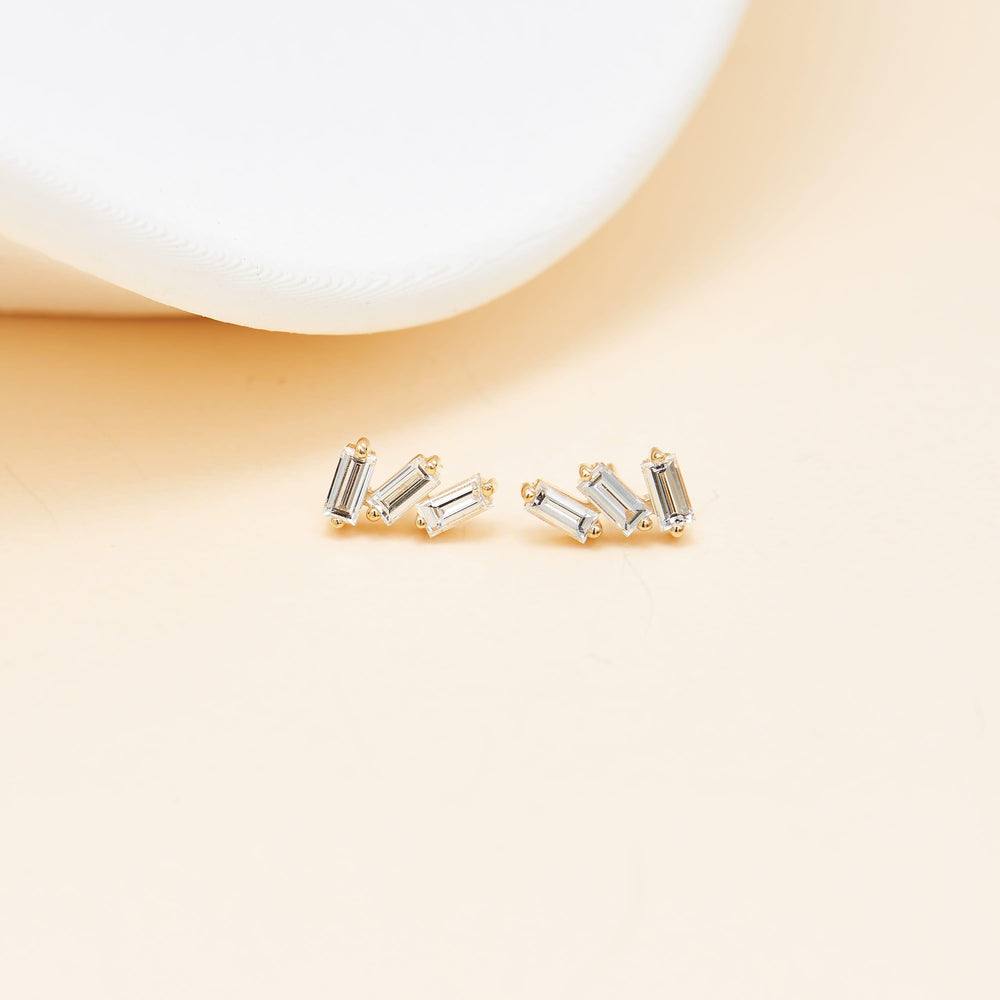 detail close-up of 14K solid gold baguette-cut lab diamond for cartilage piercing flat back stud earring nickel-free
