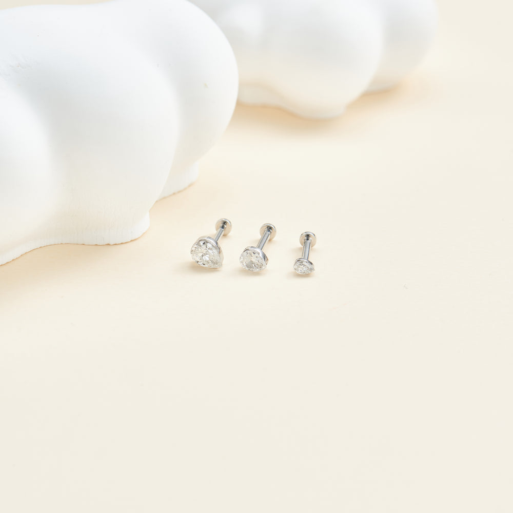 detail close-up of 14K white gold pear-cut lab diamond invisible setting flat back stud earring internal thread design nic...